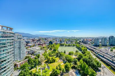 an aerial view of a city with buildings and a park at Central City Location, Bay View, One Free Parking in Vancouver