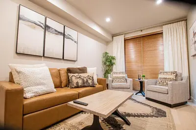 a living room with a couch and a table at Luxury Spring Creek Condo with Hot Tub in Canmore