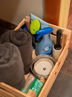 a wooden drawer with a container of cleaning products at South Swell Tofino (formerly Blue Heron Waterfront Home amid Old Growth Cedars) in Tofino