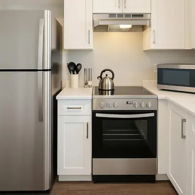 a kitchen with a stove and a refrigerator at Bright & Modern 1-Bedroom Guest Suite in Chilliwack