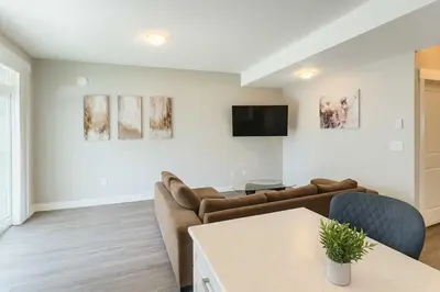 a living room with a couch and a tv at Bright & Modern 1-Bedroom Guest Suite in Chilliwack