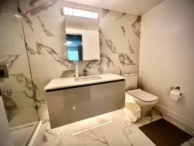 a bathroom with a sink and a toilet at Mordern stylish 2B2B close to Richmond center in Richmond
