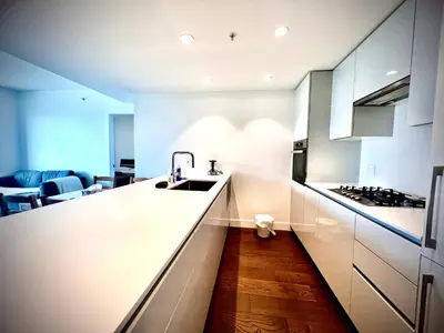 a white kitchen with a sink and a stove at Mordern stylish 2B2B close to Richmond center in Richmond