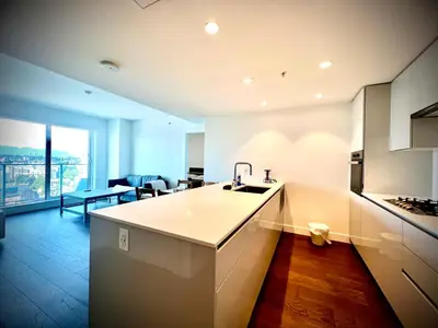 a kitchen with a sink and a counter top at Mordern stylish 2B2B close to Richmond center in Richmond
