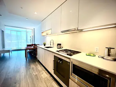 a kitchen with white cabinets and a counter top at Cozy and convenient 1B1B near Richmond center in Richmond
