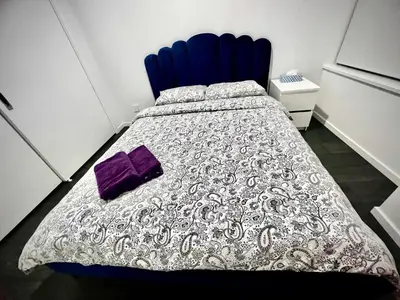 a bedroom with a bed with a purple pillow on it at Cozy and convenient 1B1B near Richmond center in Richmond