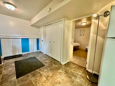 a room with a hallway with a closet and a bedroom at Beautiful Suite Fenced yard Kitchen Laundry in St. Albert