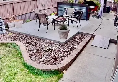a patio with chairs and a table in a backyard at Beautiful Suite Fenced yard Kitchen Laundry in St. Albert
