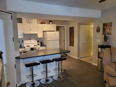 a kitchen with a counter and some bar stools at Beautiful Mountain Retreat with a View in Abbotsford