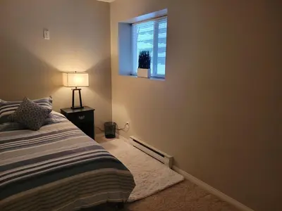 a bedroom with a bed and a window at Beautiful Mountain Retreat with a View in Abbotsford