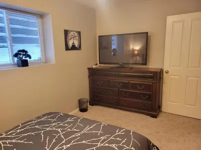 a bedroom with a dresser with a television on it at Beautiful Mountain Retreat with a View in Abbotsford