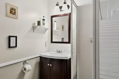 a bathroom with a sink and a mirror at Little Bear Cabin at Raven's Moon in Ucluelet