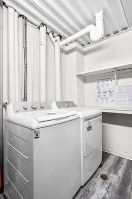 a kitchen with a stove and a dishwasher at Central Downtown at Rocky Mountain Court with Gym, Court, Sauna and Secured Parking in Calgary