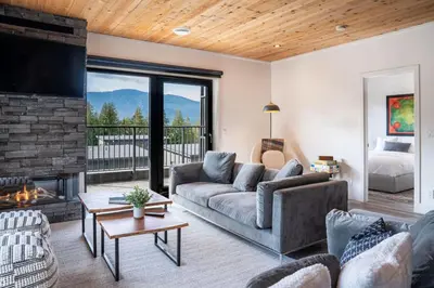 a living room with a couch and a fireplace at The Begbie Penthouse in Mackenzie Village in Revelstoke