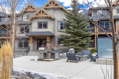 a house with a fire grill in front of it at Bears Den 2BR Getaway with Hot Tub, BBQ Near DT in Dead Man's Flats