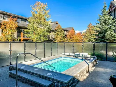 a hot tub in the backyard of a house at Bears Den 2BR Getaway with Hot Tub, BBQ Near DT in Dead Man's Flats