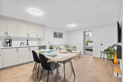 a kitchen and dining room with a table and chairs at Brand New Cozy2BR House NW Calgary DT Banff Sleep4 in Calgary