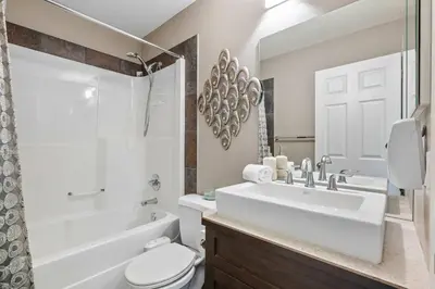 a bathroom with a sink and a toilet and a tub at Large Family Home w Kid's Play Tent! FREE Banff Pass in Calgary