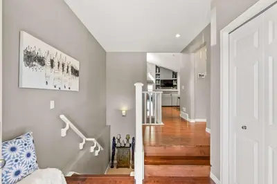 a staircase in a home with a white door at Large Family Home w Kid's Play Tent! FREE Banff Pass in Calgary