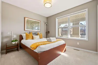 a bedroom with a large bed and a window at Large Family Home w Kid's Play Tent! FREE Banff Pass in Calgary
