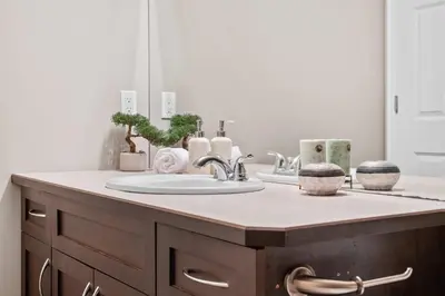 a bathroom counter with a sink and a mirror at Large Family Home w Kid's Play Tent! FREE Banff Pass in Calgary