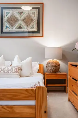 a bedroom with a bed and a table with a lamp at Large Family Home w Kid's Play Tent! FREE Banff Pass in Calgary