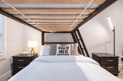 a bedroom with a large bed with a wooden ceiling at Symphony 8 by Outpost Whistler in Whistler