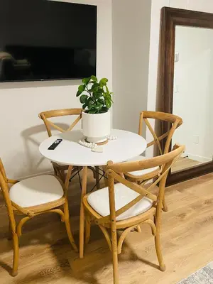 a table with two chairs and a potted plant on it at The SuiteLife, Calgary in Calgary