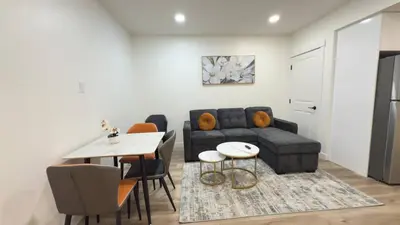 a living room with a couch and a table at Northern Nook - 2BR Suite in Calgary