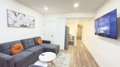 a living room with a couch and a tv at Northern Nook - 2BR Suite in Calgary