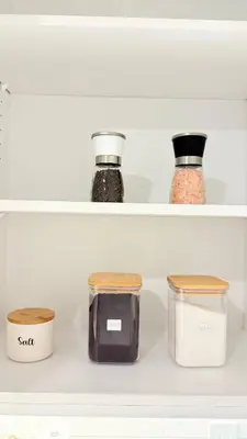 three shelves of a refrigerator with jars of food at Northern Nook - 2BR Suite in Calgary