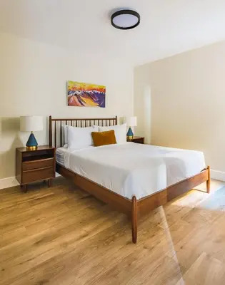 a bedroom with a large bed and two night stands at Aurora Lite - Brand new suite with private entrance in Canmore