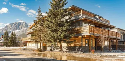a building with a tree in front of it at Aurora Lite - Brand new suite with private entrance in Canmore