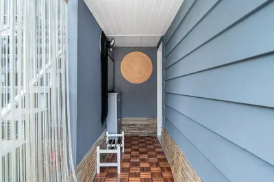 a hallway with a blue wall and a straw hat on the wall at Spacious 3BR with Full Kitchen a n dFast Wi-Fi in Vancouver