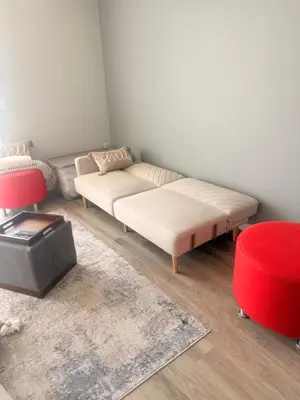 a living room with a couch and a red stool at Mollies Alpha in Langford