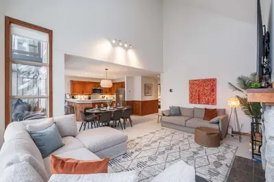 a living room with a couch and a table at Blackcomb Greens 33 by Outpost Whistler in Whistler