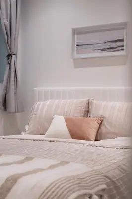 a bedroom with a white bed with a window at Brand New Cozy Suite near Collingwood School in West Vancouver