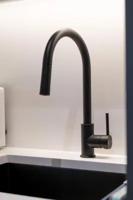 a kitchen sink with a black faucet at Brand New Cozy Suite near Collingwood School in West Vancouver