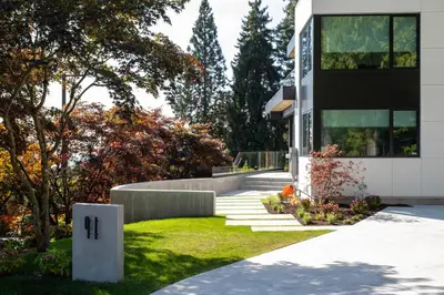 a house with a staircase leading to the front yard at Brand New Cozy Suite near Collingwood School in West Vancouver