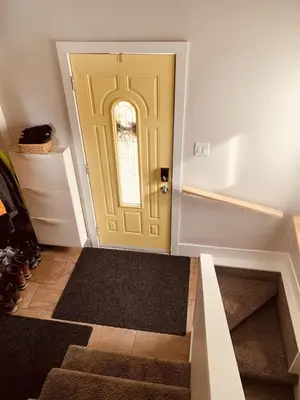 a yellow door in a room with stairs at Charming Inner City Home in Calgary