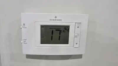 a white microwave on a wall with knives in it at Royaldee Cozy Home in Calgary