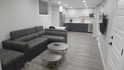 a living room with a couch and a table at Royaldee Cozy Home in Calgary