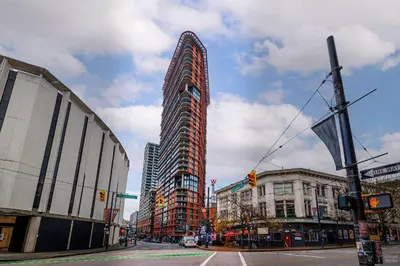 a tall building on the corner of a city street at Spacious 2BD in Vancouver Patio with Ocean View in Vancouver