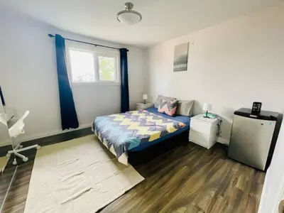 a bedroom with a bed and a window at Private Rooms in a Wonderful House in Hay River