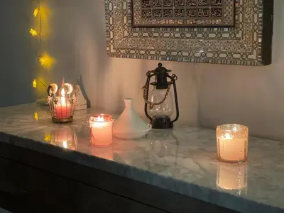 a group of candles sitting on a table with a lamp at Private Rooms in a Wonderful House in Hay River