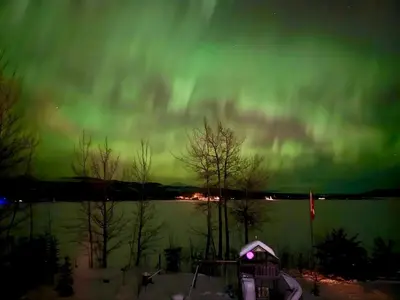 an aurora in the sky over a body of water at Suite on the Bay in Marsh Lake