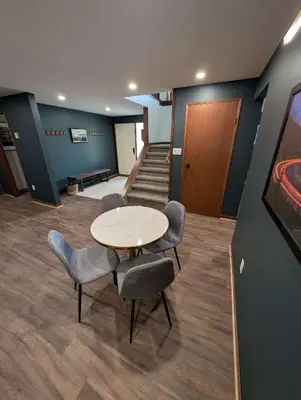 a meeting room with a table and chairs and stairs at Newly Renovated Shuswap Lake Cabin Multi-Family Retreat Sleeps 12 in Blind Bay