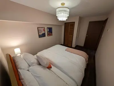 a bedroom with a bed with white sheets and pillows at Newly Renovated Shuswap Lake Cabin Multi-Family Retreat Sleeps 12 in Blind Bay