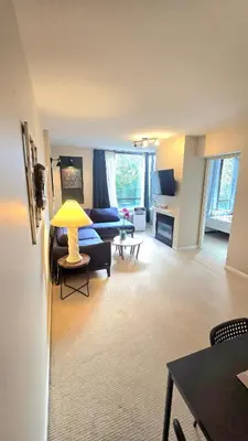 a living room with a couch and a table at Bright 2BR Close to Seabus, and Lower Lonsdale in North Vancouver