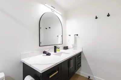 a bathroom with a sink and a mirror at Ravens Nest - Private Hot Tub in Canmore